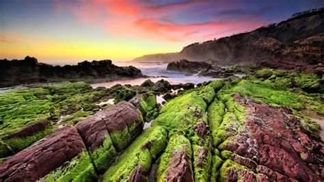 sea coast sunset rocks green moss waves indonesia landscape photography