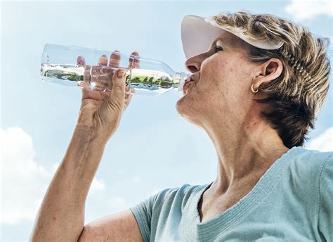 senior woman drinking  water bottle aw health care