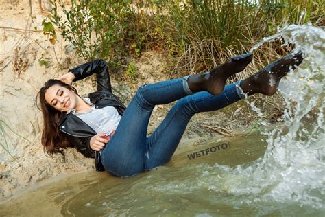 Beautiful Girl In Skinny Blue Jeans Gets Completely Wet At The Lake