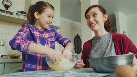 mom teaches daughter to cook stock video footage 4k and hd video