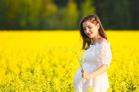 Pregnant Girl In A White Dress Outdoor Natural Portrait Of Beautiful