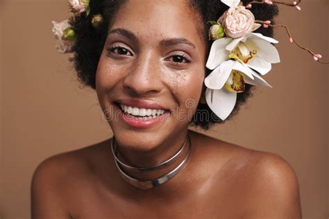 portrait of half naked african american woman with flowers in her hair