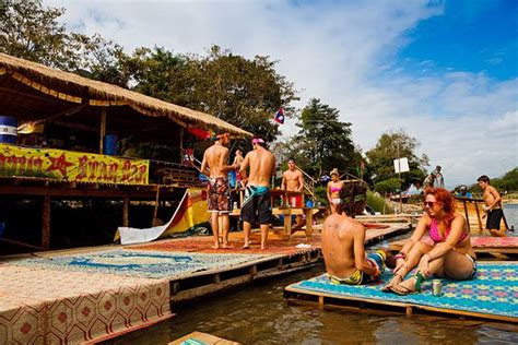 tourists tubing down the nam song river and enjoying the multiple bars