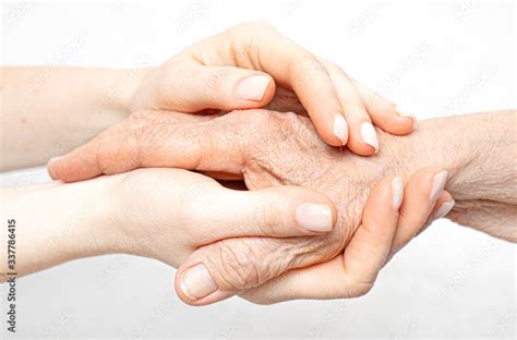 helping hand   elderly concept  young hands holding  hand stock photo adobe stock