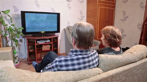 Senior Couple Watching Tv With Green Screen Sitting Sofa And Talking