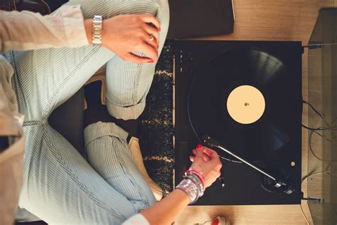 Lady Listening To Record Player Between Knees