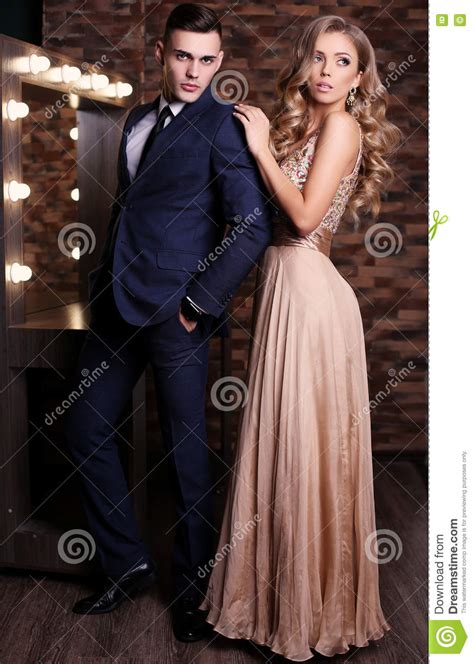 Gorgeous Woman With Blond Hair And Handsome Man In Elegant
