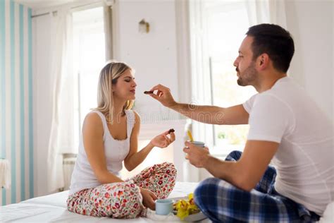 Young Couple Having Having Romantic Times In Bedroom Stock Image