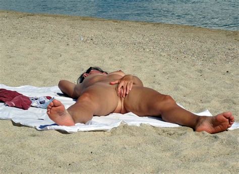 sluts sunbathes nude on the beach
