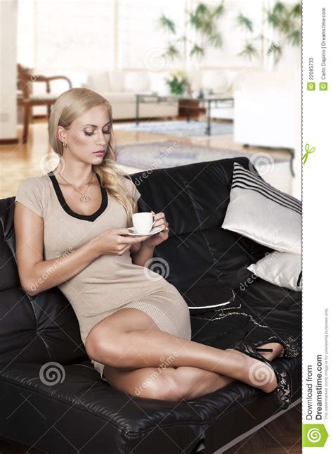 Sitting On Sofa Drinking From A Cup Stock Image Image Of