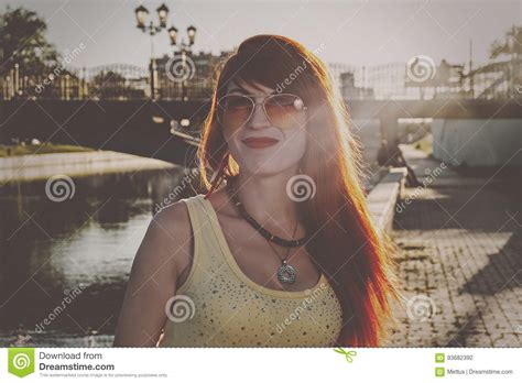Head And Shoulders Of Ginger Hair Woman In Orange Color Sunglasses