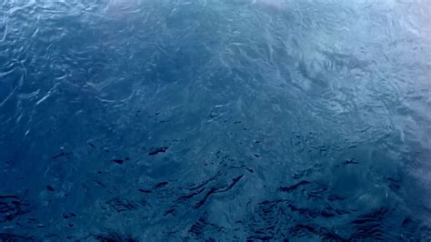 overhead view rippling blue water slow motion loop musictruth background