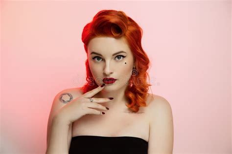 portrait of a beautiful red hair girl with pin up make up and hair