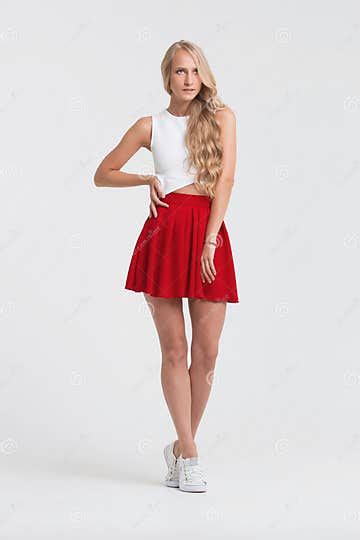 Girl With Perfect Body In Red Skirt On A White Background Stock Image