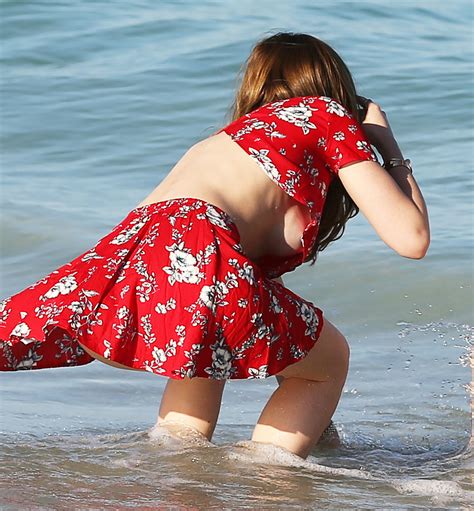 bella thorne flashes underboob works beach body in tiny bikini