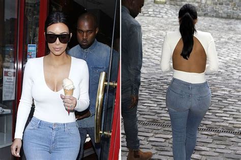 kim kardashian flaunts slim figure in backless top and tight jeans as
