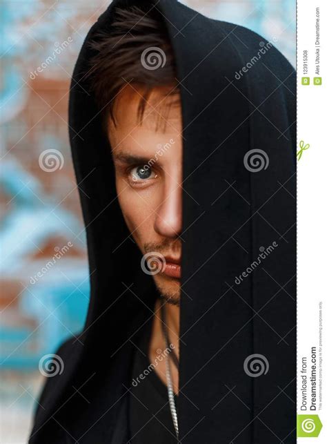 Portrait Of A Handsome Man In A Black Hood Hidden Face