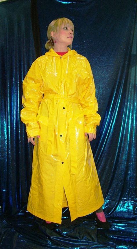 protected in her long yellow mackintosh pvc raincoat plastic raincoat