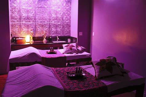 couple  beds   room  purple lighting   wall   pillows
