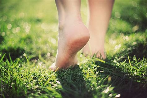 walking barefoot across the grass by kitty kleyn stocksy united