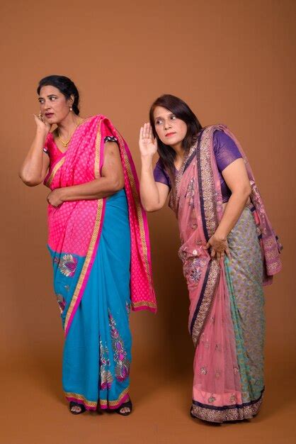 premium photo two mature indian women wearing sari indian traditional