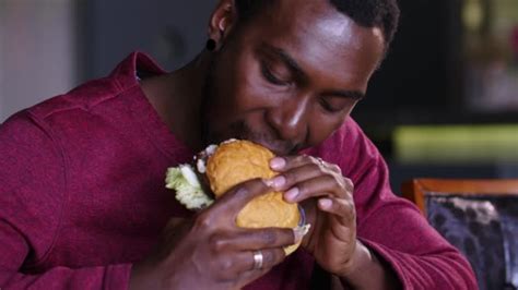fat black guy eating cheeseburger stock videos and royalty