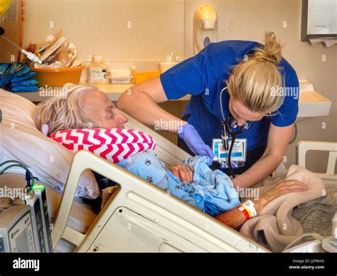 A Registered Nurse Examines A Recovering Surgery Patient S Wound At An