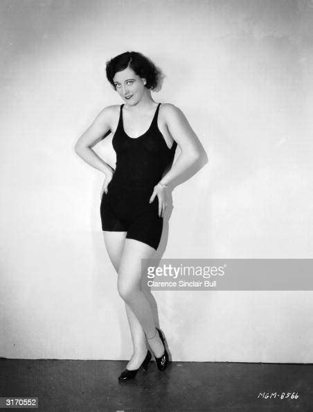 American Actress Joan Crawford Wearing A Dark Swimsuit With High