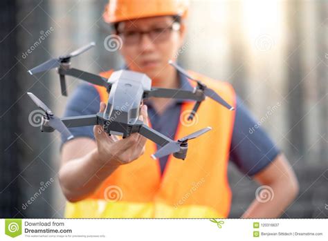 young asian engineer holding drone  construction site stock image image  aerial flying