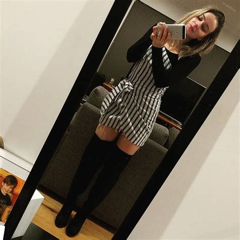 Mirror Selfie Of Black Thigh High Boots On Bare Legs With Short Dress