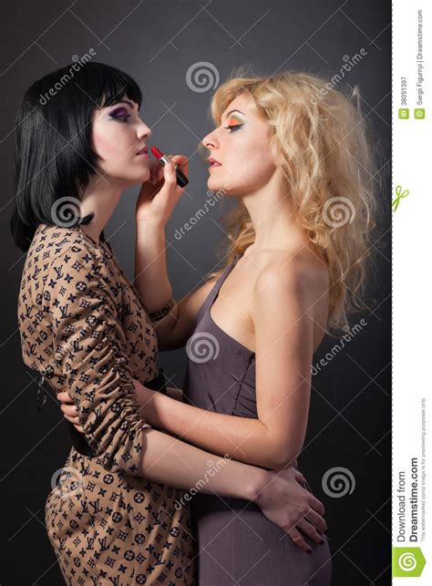 Two Young Attractive Lesbians Are Hugging With A Lipstick Stock Image