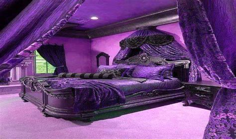 a bedroom with purple walls and an ornate bed in the center along with