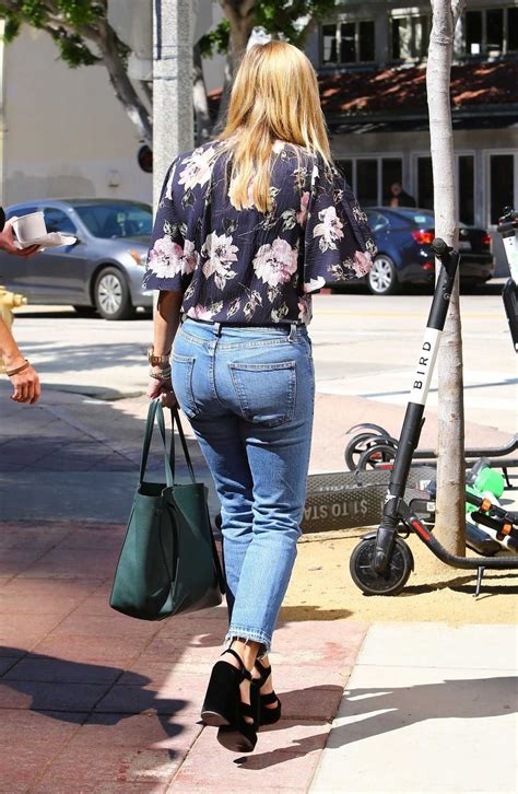 reese witherspoon in a blue jeans leaves tender greens in