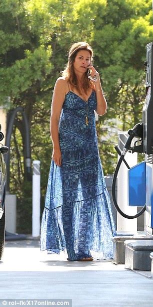 cindy crawford wears see through summer dress while she fills up her