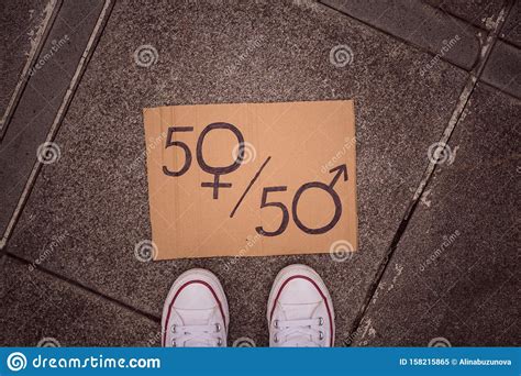 Gender Equality Concept As Woman Legs And Paper Sheet With Male And