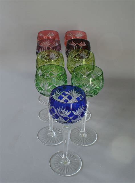 A Set Of Nine Multi Coloured Cut Glass Crystal Hock Or Wine Glasses