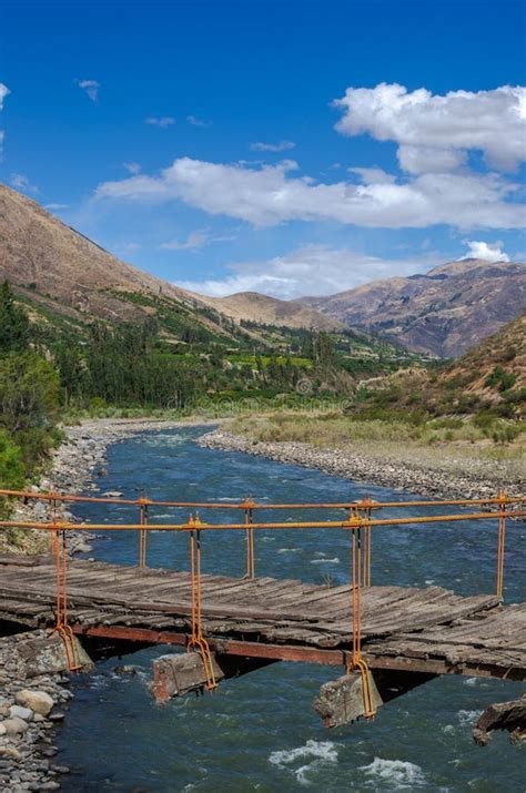 wooden suspension bridge held  ropes  river  valley stock photo image  outdoor