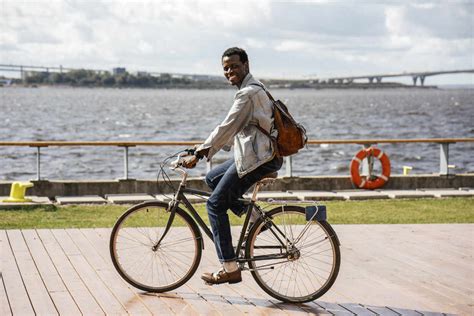 young man riding bicycle   sea stock photo
