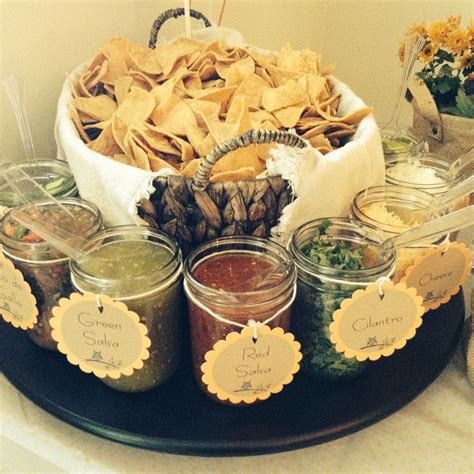 Chips In Basket Then Various Salsas And Toppings In Pint Jars Use