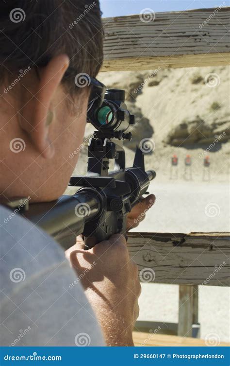 man aiming rifle  firing range stock photography cartoondealercom