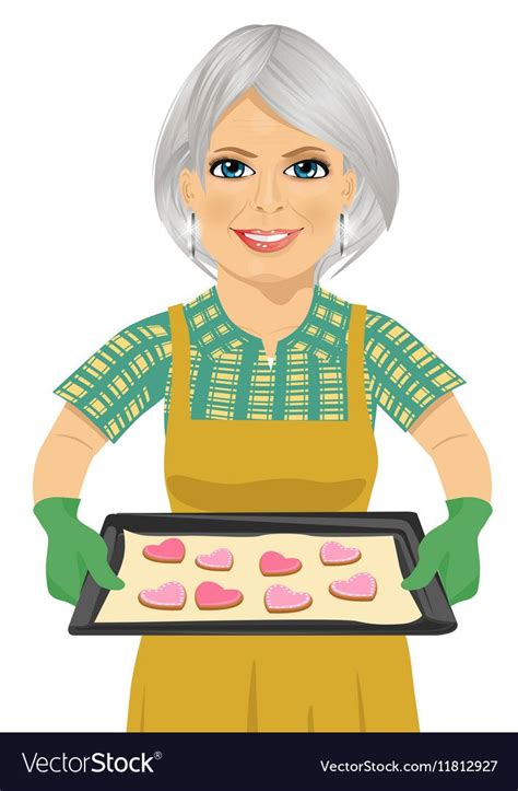 Senior Woman Holding Baking Tray With Heart Shape Cookies Over White