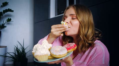 eating woman enjoy cream cupcake food calories close up hungry