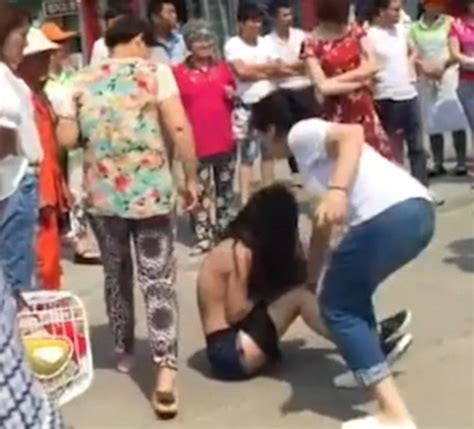 horrifying video shows a woman strip and beat her husband s alleged mistress in public daily