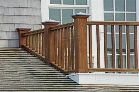 wooden balcony railing  shingled roof stock photo dissolve