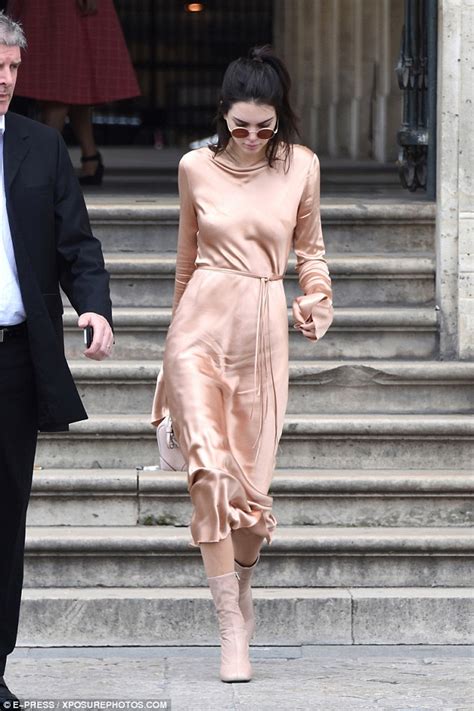 braless kendall jenner shows off her nipple piercing in a pink satin