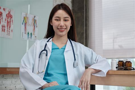 Portrait Of Beautiful Female Doctor Of Asian Ethnicity In Uniform With
