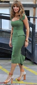 carol vorderman distracts from her new blonde do as she pours herself into a very tight dress