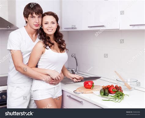 Happy Young Loving Couple Cooking Together In The Kitchen At Home Stock