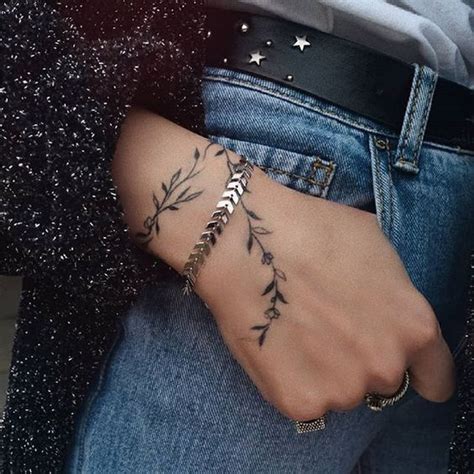 simple vine leaf tattoo around the wrist tatuajes