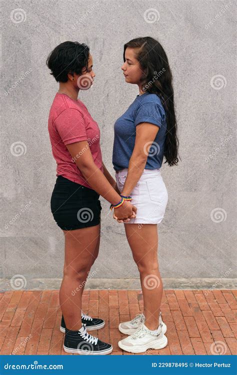 Latina Lesbian Couple Stare At Each Other During A Date In The City
